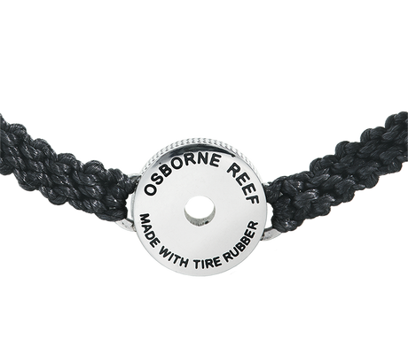 This black macrame bracelet is hand braided using 100% recycled plastic cord. Designed to represent the tires we’re recovering from the Osborne Reef, the tire-shaped bezel is filled with verified 100% crumb rubber from tires that our crews recovered directly from the Osborne Reef.