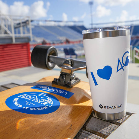 Set of stickers on the bottom of a skateboard and a reusable tumbler